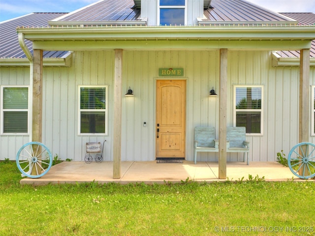 23814 E 91st St S, Broken Arrow, OK 74014 - doorway to property featuring metal roof and a lawn
