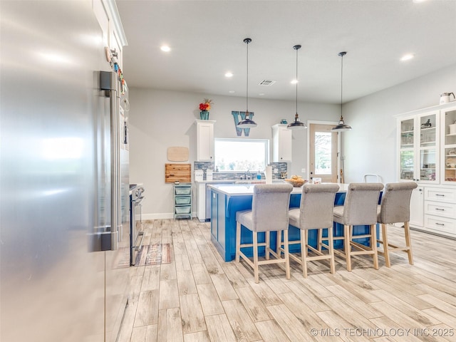 23814 E 91st St S, Broken Arrow, OK 74014 - kitchen with appliances with stainless steel finishes, white cabinetry, light countertops, a center island, and recessed lighting