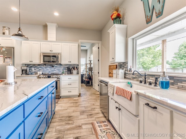 23814 E 91st St S, Broken Arrow, OK 74014 - kitchen with blue cabinets, appliances with stainless steel finishes, white cabinets, tasteful backsplash, and recessed lighting