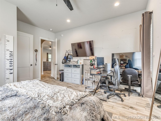 23814 E 91st St S, Broken Arrow, OK 74014 - bedroom featuring light wood-type flooring, a desk, arched walkways, and ceiling fan