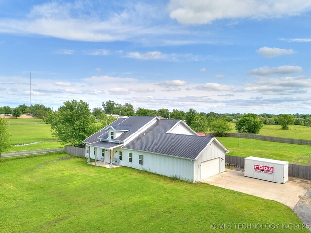 23814 E 91st St S, Broken Arrow, OK 74014 - view of front of home featuring concrete driveway, metal roof, an attached garage, a rural view, and a standing seam roof