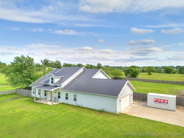 23814 E 91st St S, Broken Arrow, OK 74014 - back of property featuring driveway, metal roof, and an attached garage