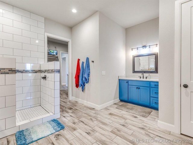 23814 E 91st St S, Broken Arrow, OK 74014 - bathroom featuring a walk in shower, vanity, wood finished floors, baseboards, and recessed lighting