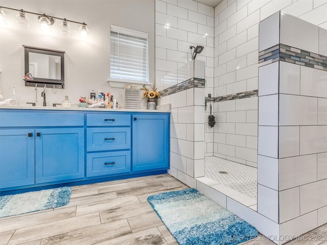 23814 E 91st St S, Broken Arrow, OK 74014 - full bathroom featuring walk in shower, double vanity, and wood finished floors