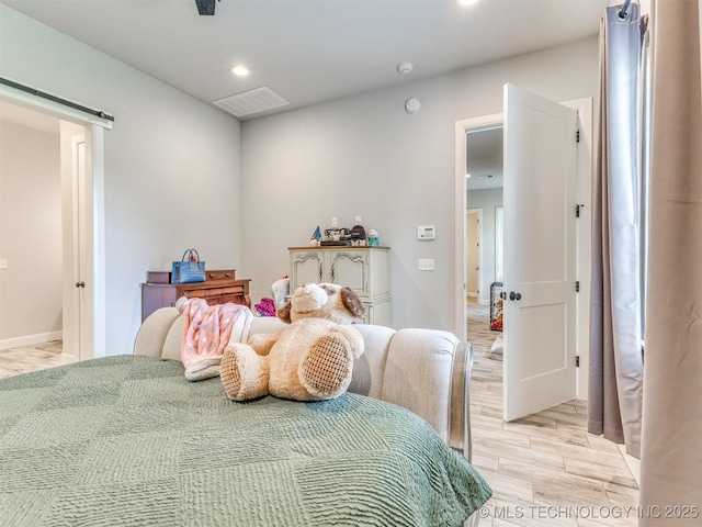 23814 E 91st St S, Broken Arrow, OK 74014 - bedroom featuring recessed lighting, a barn door, light wood-style floors, and baseboards