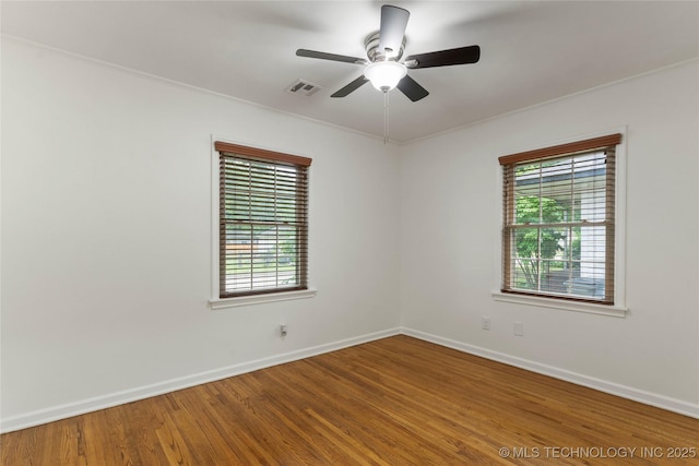 4514 S Quaker Ave, Tulsa, OK 74105 - unfurnished room with healthy amount of natural light, baseboards, wood finished floors, and crown molding