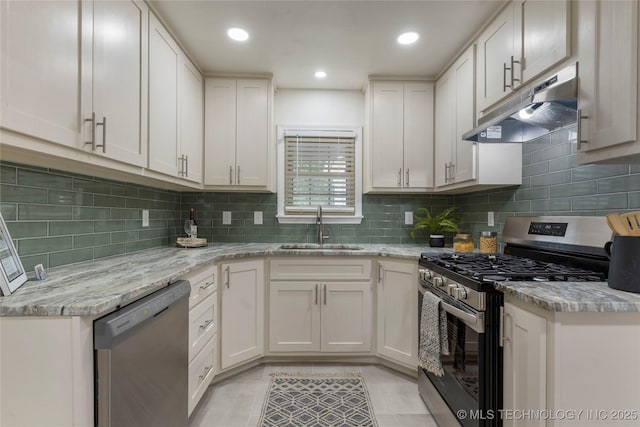 4514 S Quaker Ave, Tulsa, OK 74105 - kitchen with stainless steel appliances, under cabinet range hood, a sink, decorative backsplash, and white cabinetry
