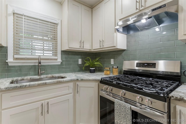 4514 S Quaker Ave, Tulsa, OK 74105 - kitchen featuring stainless steel gas range oven, under cabinet range hood, a sink, tasteful backsplash, and white cabinetry