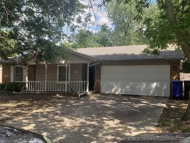 3001 S Ash Ct, Broken Arrow, OK 74012 - single story home with driveway, a garage, a porch, and brick siding