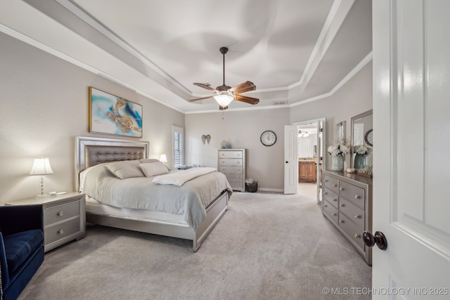 7734 S Indian Ave, Tulsa, OK 74132 - carpeted bedroom with a raised ceiling, ornamental molding, connected bathroom, a ceiling fan, and baseboards
