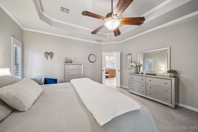 7734 S Indian Ave, Tulsa, OK 74132 - bedroom featuring a tray ceiling, ornamental molding, light carpet, baseboards, and connected bathroom