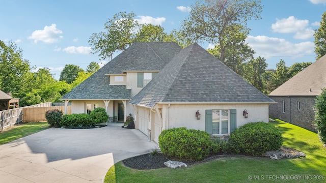 7734 S Indian Ave, Tulsa, OK 74132 - view of front of home featuring driveway, stucco siding, a shingled roof, and an attached garage