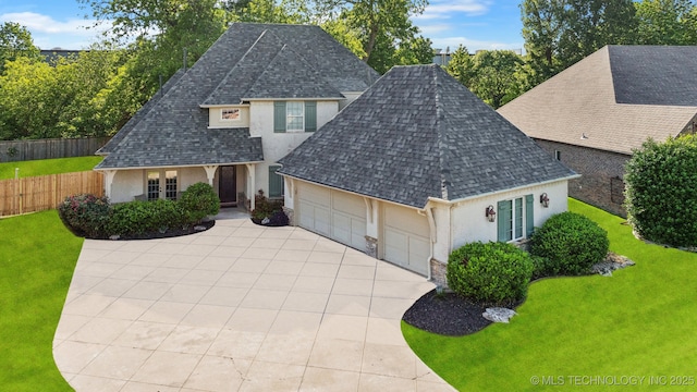 7734 S Indian Ave, Tulsa, OK 74132 - traditional-style home featuring stucco siding, a shingled roof, an attached garage, and driveway