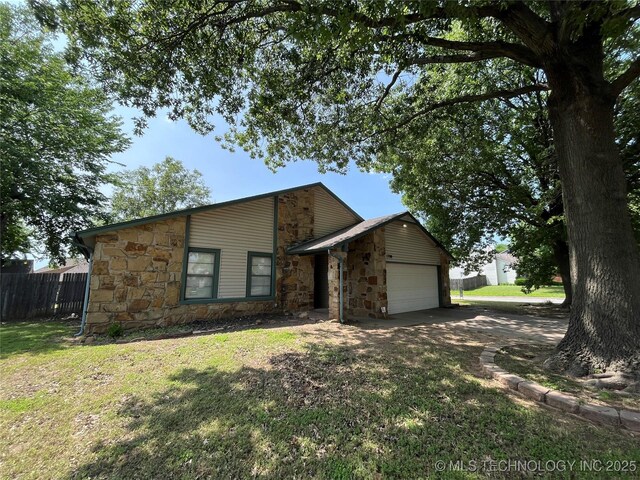 1700 S Cypress Ave, Broken Arrow, OK 74012 - mid-century home with stone siding, a garage, and driveway