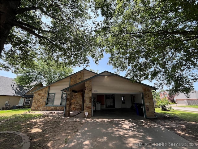 1700 S Cypress Ave, Broken Arrow, OK 74012 - view of front facade featuring stone siding, driveway, and a garage