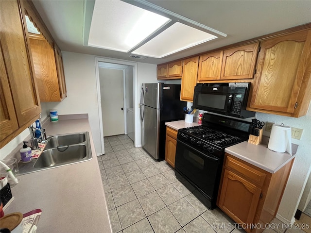1700 S Cypress Ave, Broken Arrow, OK 74012 - kitchen with black appliances, light tile patterned floors, light countertops, and brown cabinets