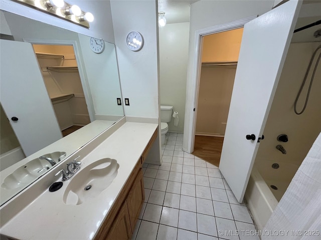 1700 S Cypress Ave, Broken Arrow, OK 74012 - bathroom with a walk in closet, vanity, tile patterned floors, and shower / bath combo