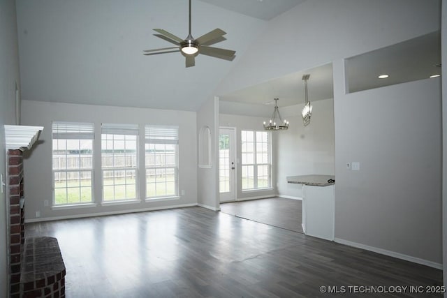 15310 E 89th Pl, Owasso, OK 74055 - unfurnished living room featuring high vaulted ceiling, a chandelier, plenty of natural light, a ceiling fan, and dark wood-style flooring