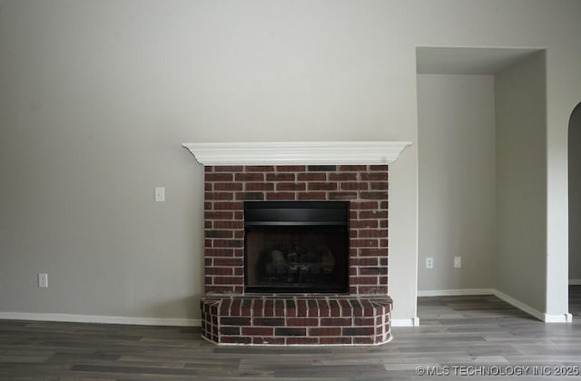 15310 E 89th Pl, Owasso, OK 74055 - detailed view of a fireplace, wood finished floors, baseboards, and arched walkways