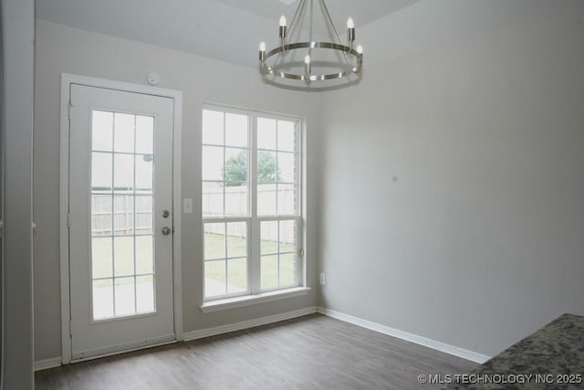 15310 E 89th Pl, Owasso, OK 74055 - doorway to outside with a chandelier, wood finished floors, and baseboards