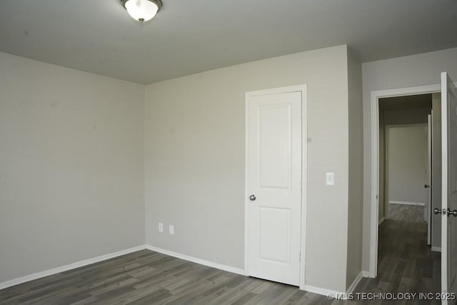 15310 E 89th Pl, Owasso, OK 74055 - unfurnished bedroom with wood finished floors and baseboards