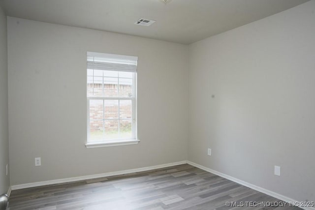 15310 E 89th Pl, Owasso, OK 74055 - spare room featuring wood finished floors and baseboards