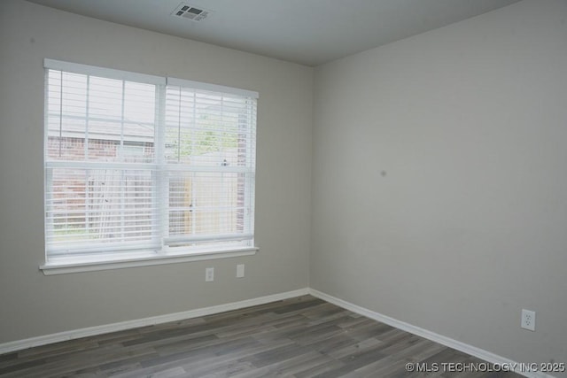 15310 E 89th Pl, Owasso, OK 74055 - spare room with plenty of natural light, wood finished floors, and baseboards