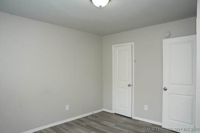 15310 E 89th Pl, Owasso, OK 74055 - unfurnished bedroom with wood finished floors and baseboards