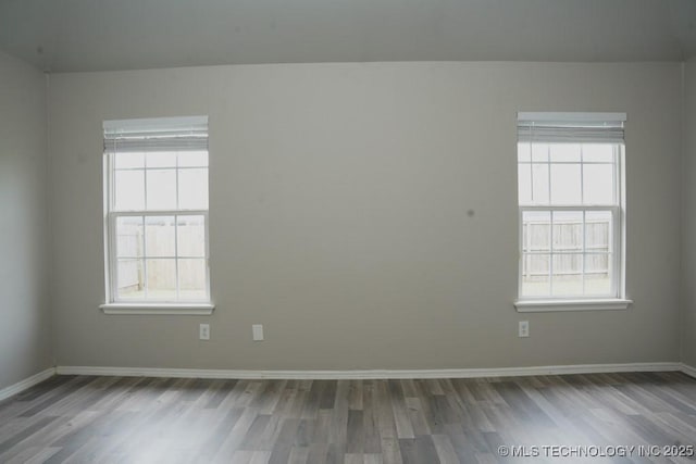 15310 E 89th Pl, Owasso, OK 74055 - unfurnished room with wood finished floors, healthy amount of natural light, and baseboards