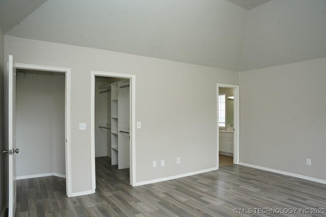 15310 E 89th Pl, Owasso, OK 74055 - unfurnished bedroom with a spacious closet, wood finished floors, baseboards, and a closet