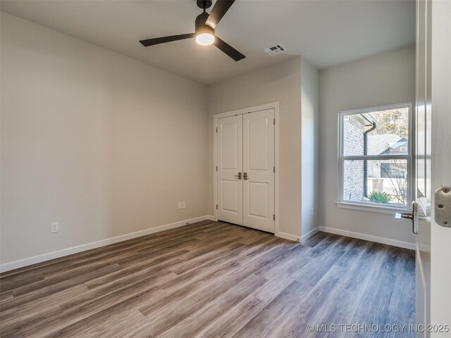 3011 S 6th Pl, Broken Arrow, OK 74012 - unfurnished bedroom featuring wood finished floors, baseboards, a closet, and a ceiling fan