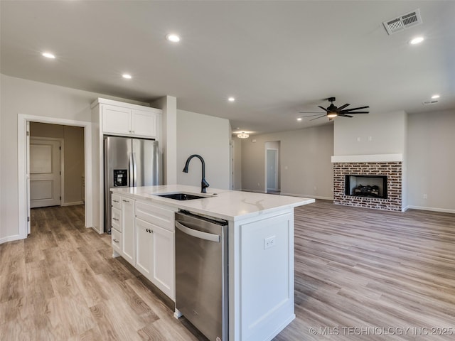 3011 S 6th Pl, Broken Arrow, OK 74012 - kitchen with stainless steel appliances, a sink, a ceiling fan, white cabinetry, and recessed lighting
