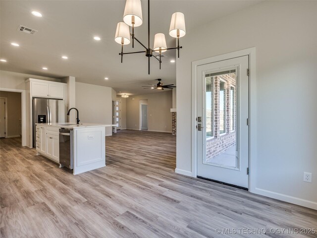 3011 S 6th Pl, Broken Arrow, OK 74012 - kitchen featuring a sink, white cabinets, open floor plan, baseboards, and recessed lighting