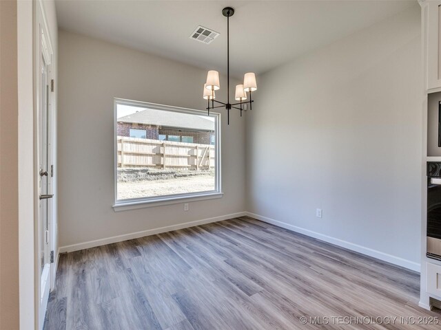 3011 S 6th Pl, Broken Arrow, OK 74012 - empty room with plenty of natural light, a chandelier, and wood finished floors