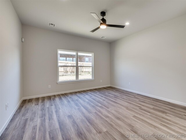 3011 S 6th Pl, Broken Arrow, OK 74012 - unfurnished room featuring wood finished floors, ceiling fan, baseboards, and recessed lighting