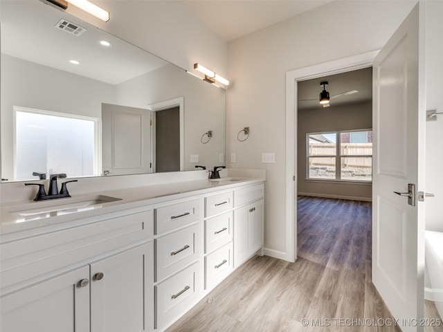 3011 S 6th Pl, Broken Arrow, OK 74012 - full bathroom featuring double vanity, wood finished floors, baseboards, and recessed lighting