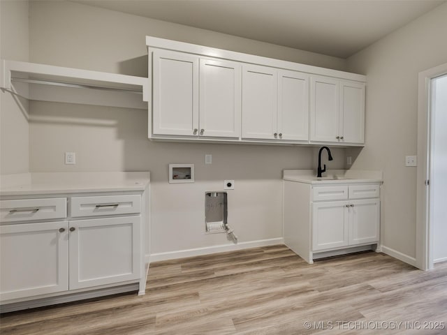 3011 S 6th Pl, Broken Arrow, OK 74012 - laundry area featuring cabinet space, hookup for a washing machine, hookup for an electric dryer, baseboards, and light wood-type flooring