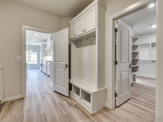 3011 S 6th Pl, Broken Arrow, OK 74012 - mudroom with light wood-style floors, baseboards, and a chandelier