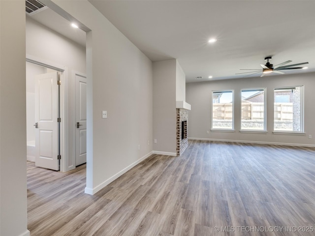 3011 S 6th Pl, Broken Arrow, OK 74012 - unfurnished living room featuring light wood-style flooring, ceiling fan, baseboards, a brick fireplace, and recessed lighting