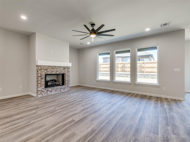 3011 S 6th Pl, Broken Arrow, OK 74012 - unfurnished living room featuring a ceiling fan, wood finished floors, baseboards, recessed lighting, and a fireplace