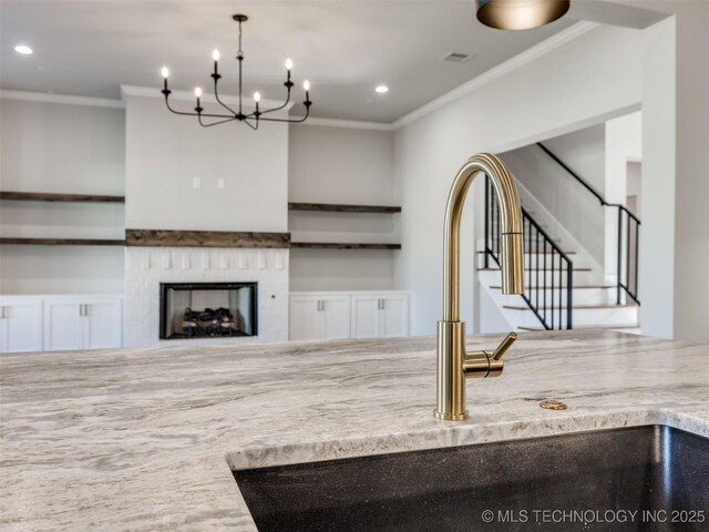 4010 W Baton Rouge St, Broken Arrow, OK 74011 - unfurnished living room featuring crown molding, a sink, a chandelier, recessed lighting, and stairs