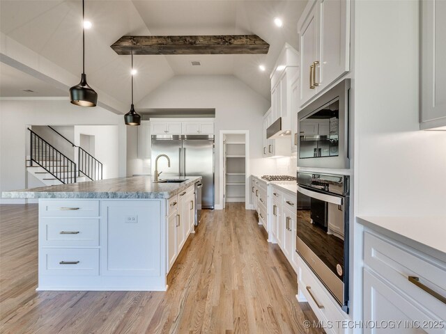 4010 W Baton Rouge St, Broken Arrow, OK 74011 - kitchen featuring built in appliances, a sink, light wood-style flooring, and white cabinets