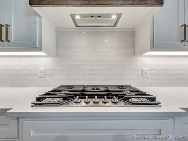 4010 W Baton Rouge St, Broken Arrow, OK 74011 - kitchen with stainless steel gas stovetop, light countertops, exhaust hood, and backsplash