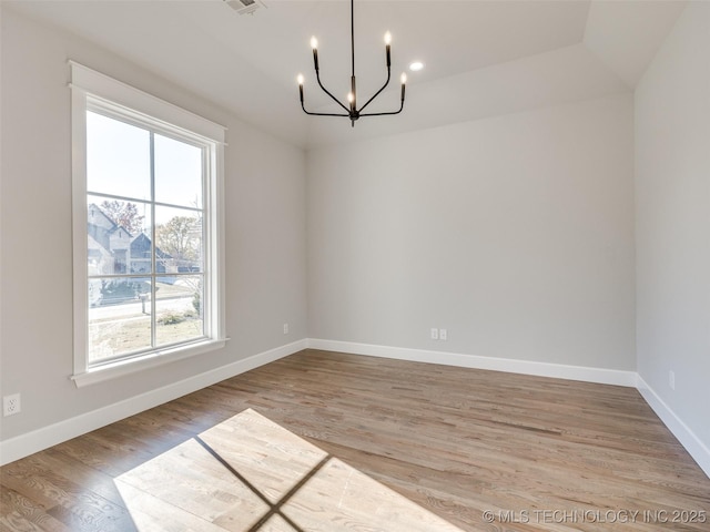 4010 W Baton Rouge St, Broken Arrow, OK 74011 - empty room featuring plenty of natural light, a chandelier, and wood finished floors