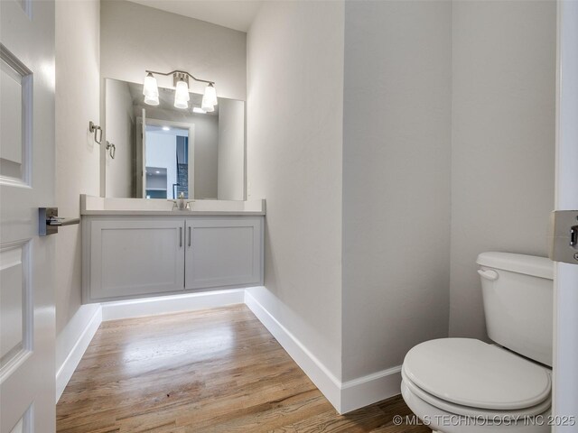 4010 W Baton Rouge St, Broken Arrow, OK 74011 - half bathroom featuring toilet, wood finished floors, baseboards, and vanity