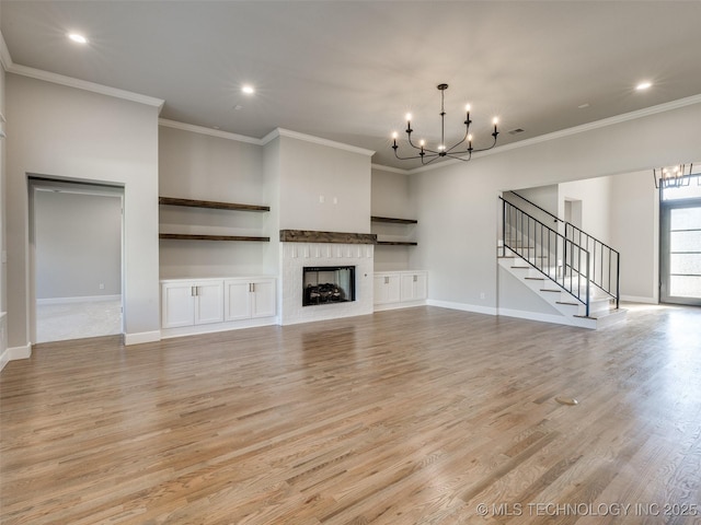 4010 W Baton Rouge St, Broken Arrow, OK 74011 - unfurnished living room with a chandelier, light wood-style floors, ornamental molding, stairs, and a fireplace