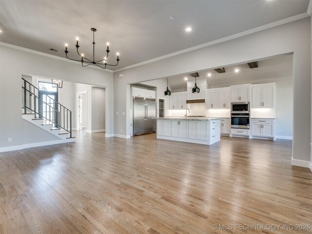 4010 W Baton Rouge St, Broken Arrow, OK 74011 - unfurnished living room with a chandelier, a sink, ornamental molding, light wood-style flooring, and baseboards