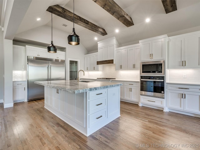 4010 W Baton Rouge St, Broken Arrow, OK 74011 - kitchen featuring built in appliances, tasteful backsplash, white cabinetry, an island with sink, and light wood finished floors