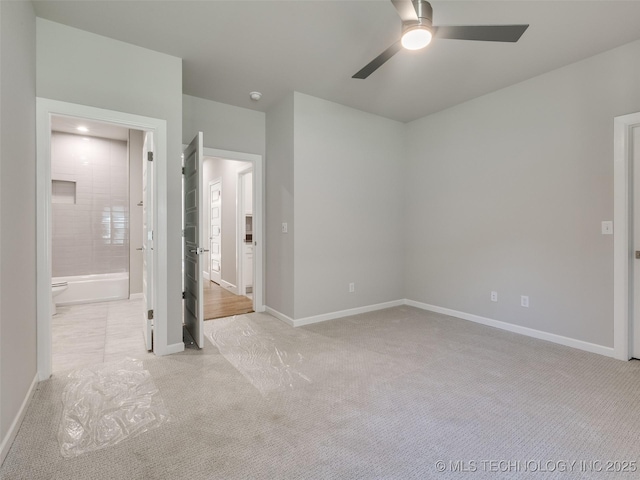 4010 W Baton Rouge St, Broken Arrow, OK 74011 - unfurnished bedroom featuring light carpet, baseboards, ensuite bathroom, and ceiling fan