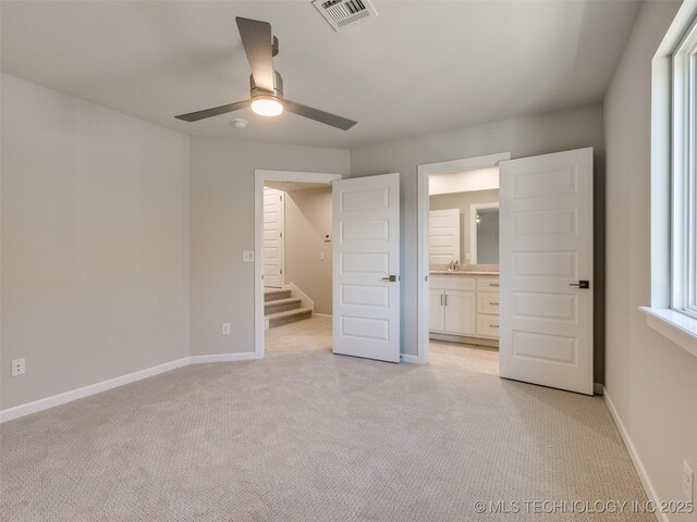 4010 W Baton Rouge St, Broken Arrow, OK 74011 - unfurnished bedroom with light carpet, baseboards, connected bathroom, a sink, and ceiling fan
